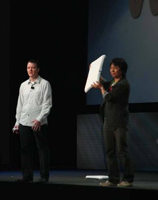 Nintendo's Shigeru Miyamoto shows off the Wii Balance Board.