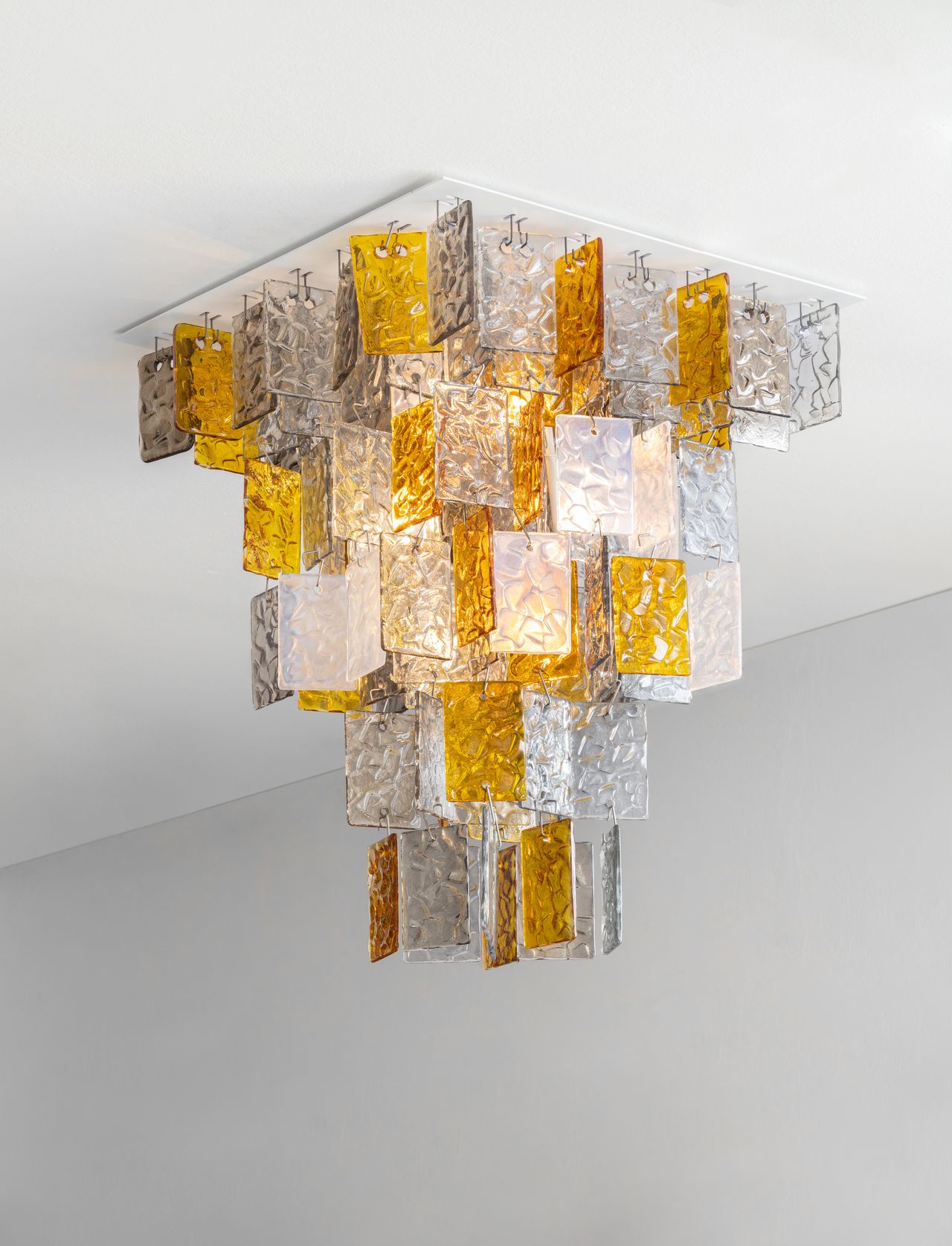 A Murano glass chandelier in transparent and yellow-hued tiles.