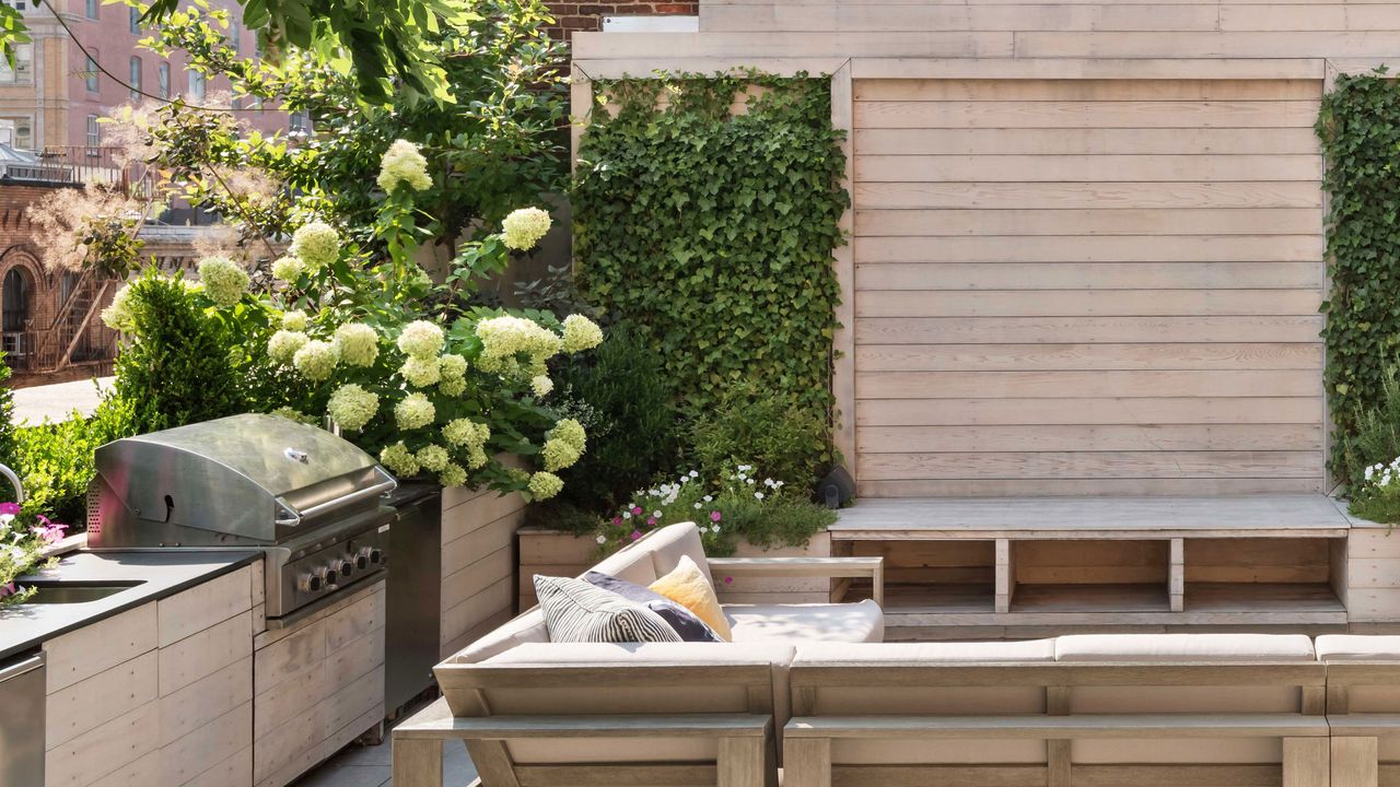 an outdoor kitchen with a hydrangea bush