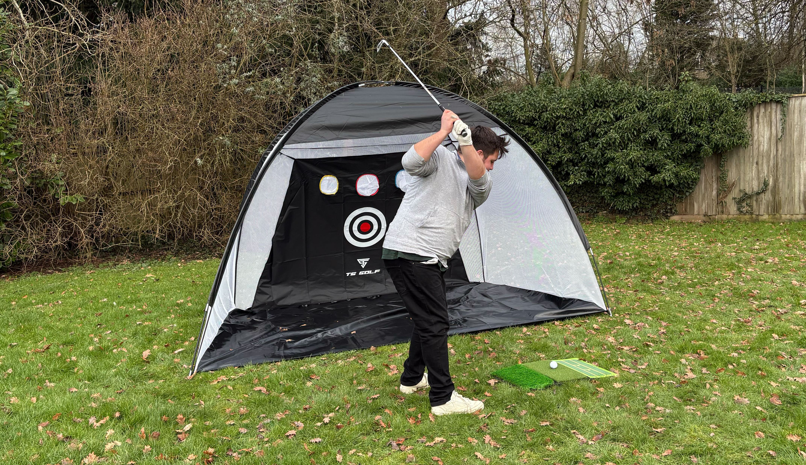 A golfer hits into the TS Golf Practice Net