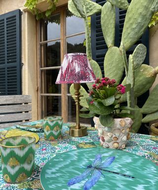 outdoor table with patterned accessories and lamp