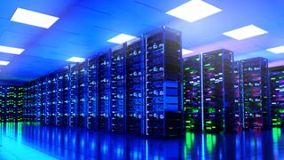 A data center with racks of servers and lots of lights glowing