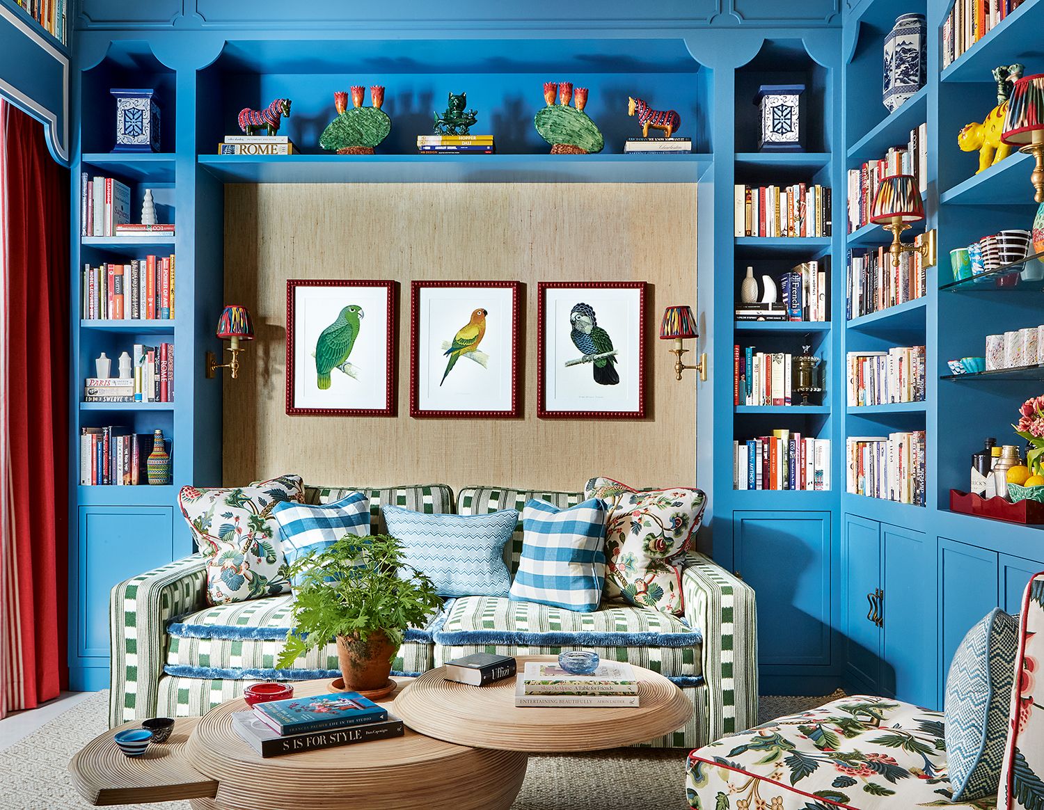 blue living room with blue sofa and red curtains