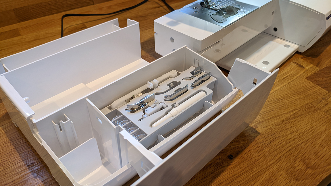 Brother Innovis NV1800Q review, a photo of the tool storage tray inside a sewing machine