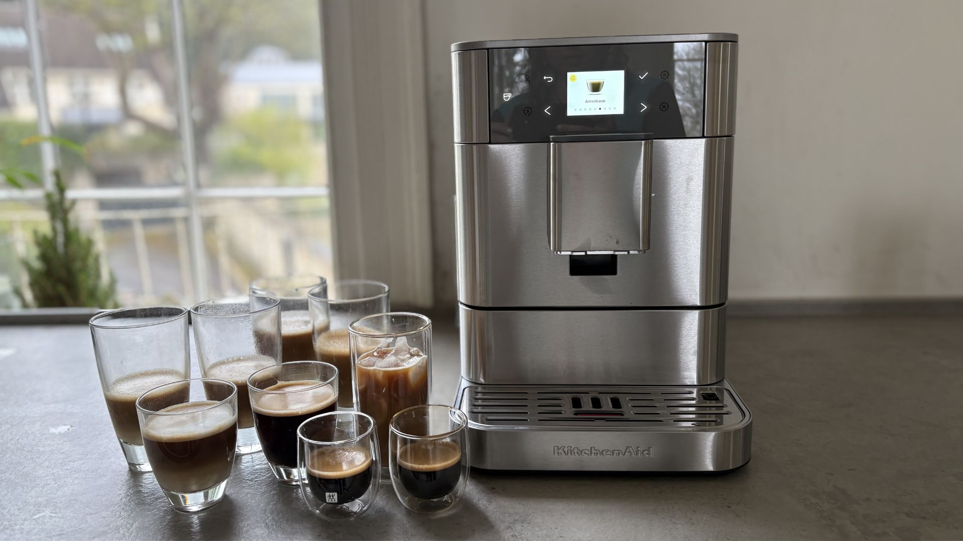 Testing the KitchenAid KF6 Fully Automatic Espresso Machine with coffee around it
