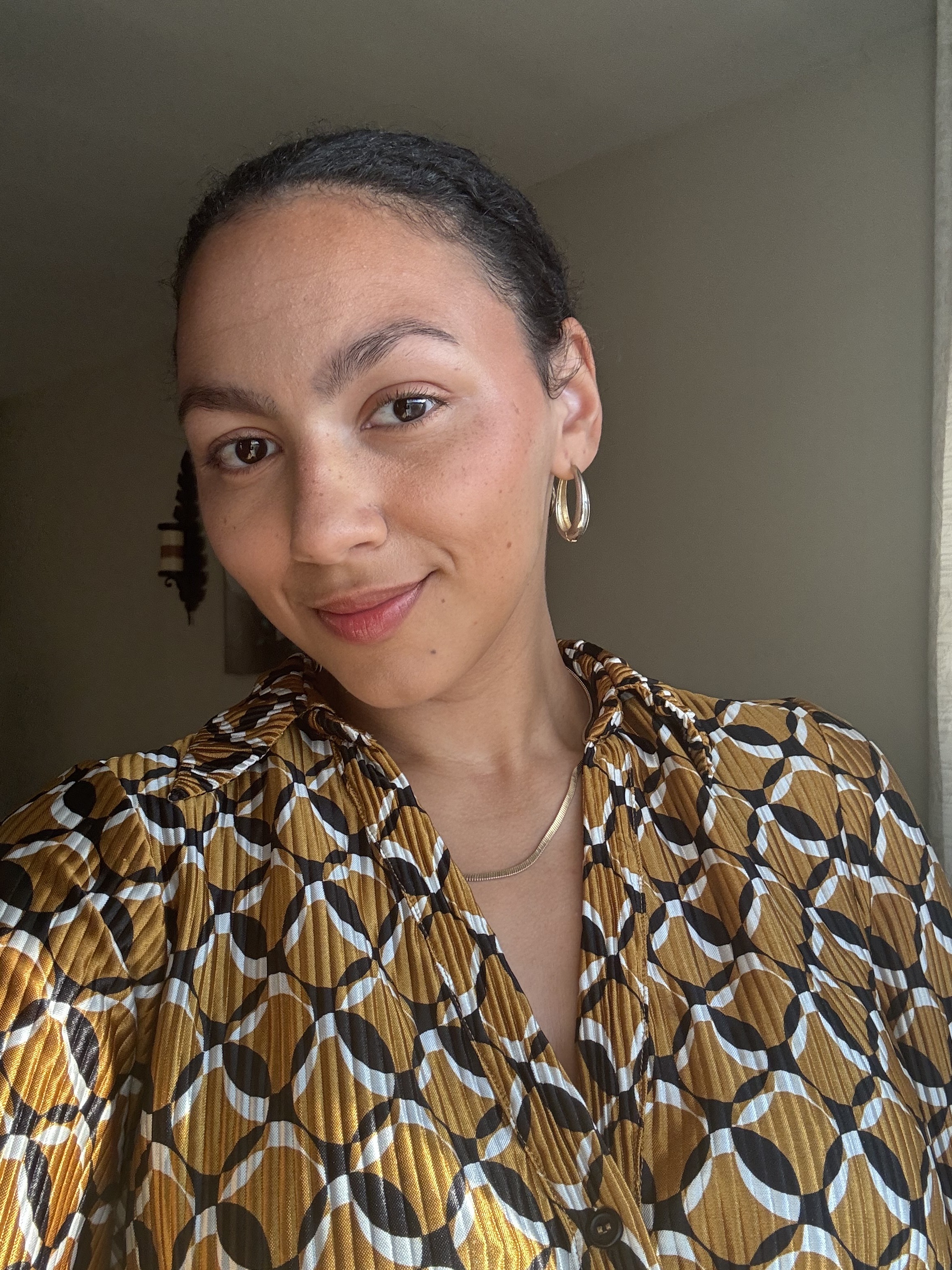 An selfie of Sabrina Talbert wearing a yellow, black, and white top.