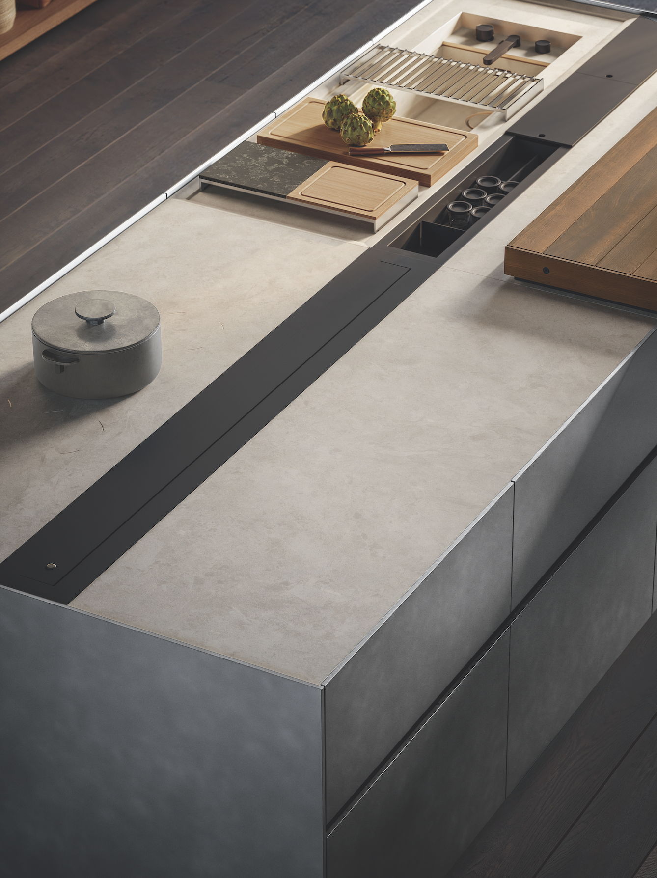 A kitchen island with a sliding panel, under which sockets are hidden