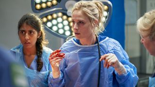 Dr Lucinda Edwards (Niamh Algar) in bloody gloves and scrubs in Malpractice