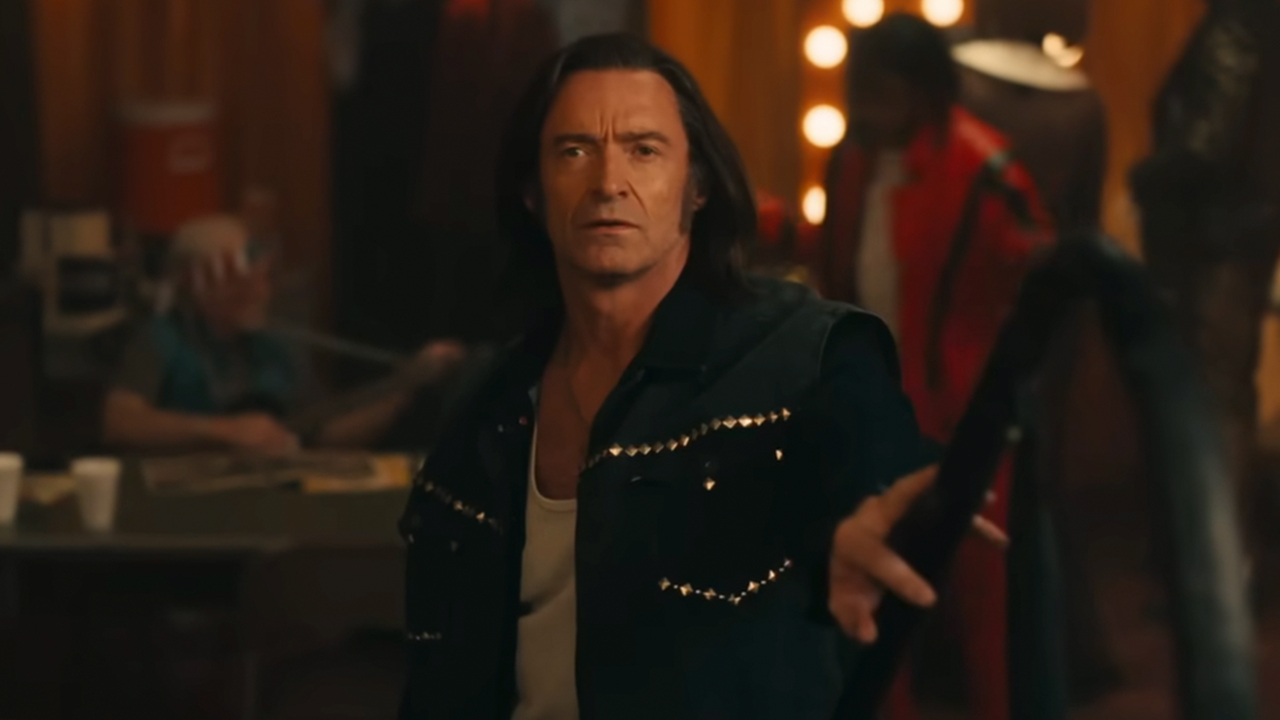 Hugh Jackman in a rhinestone-studded jacket and with long hair in Song Sung Blue