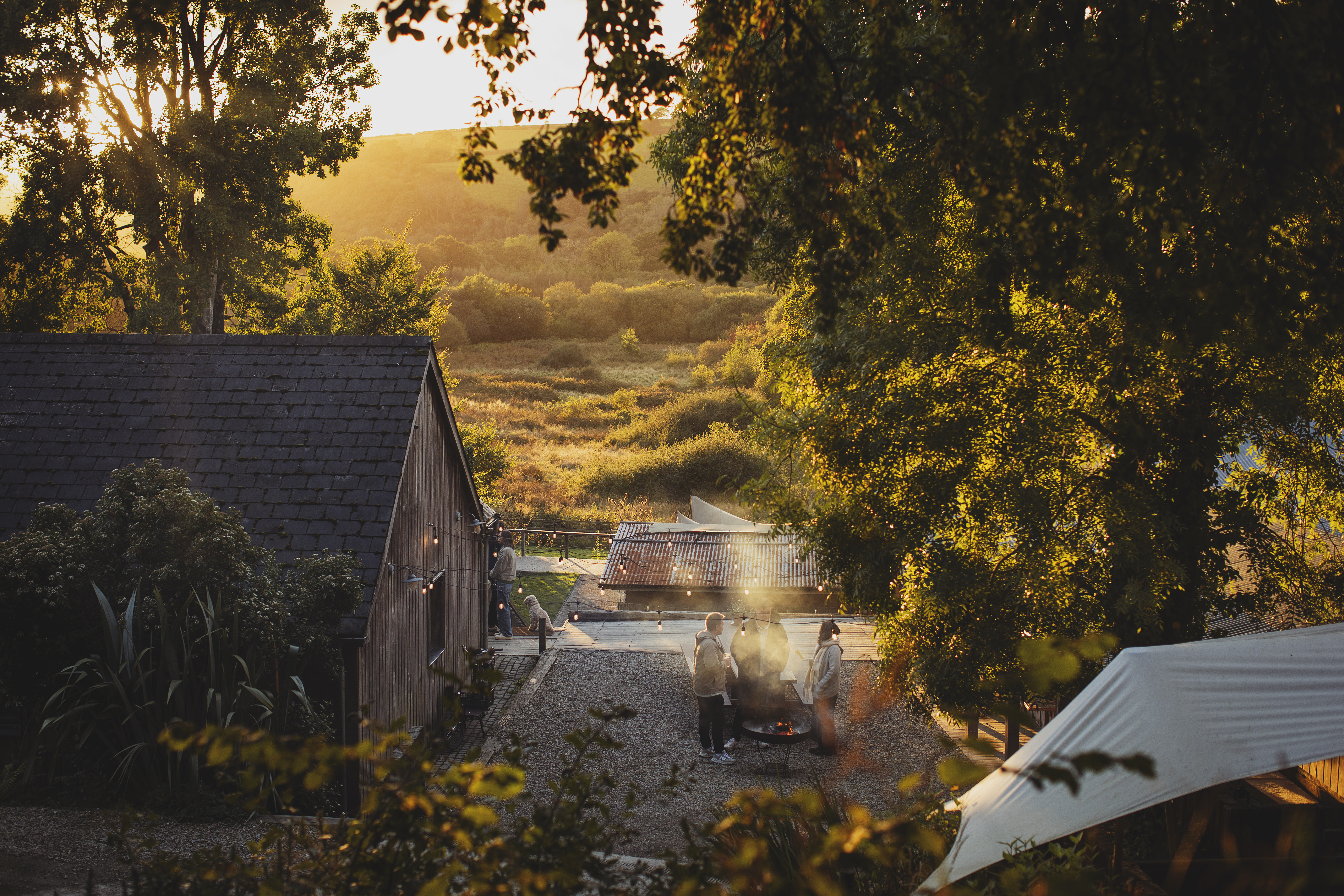 Wood cabin in green valley at sunrise