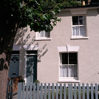 house exterior with white windows and grey door