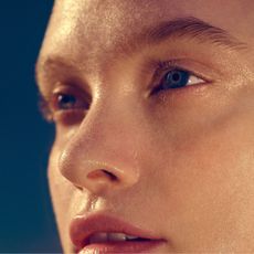 a model with a very wet and shiny face