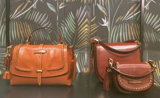 Shoulder bags with tassel details and gold studs in a range of tans and browns.
