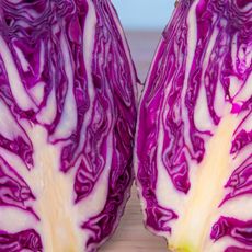very close up of purple cabbage on cutting board 