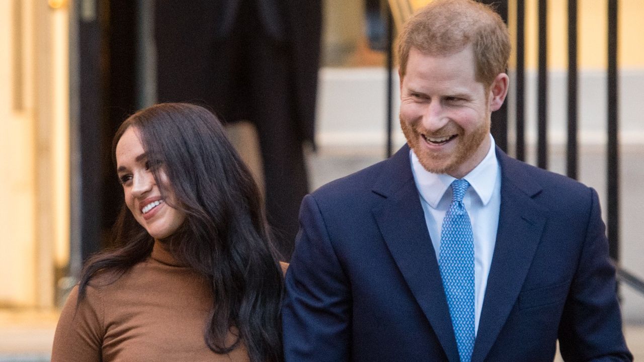 Prince Harry and Meghan Markle hold hands and walk out of an engagement