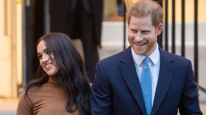 Prince Harry and Meghan Markle hold hands and walk out of an engagement