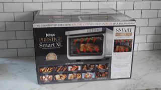 Ninja Prestige Smart XL Air Fryer & Countertop Oven being tested in a white kitchen