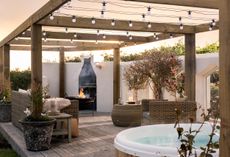 Decking area with hot tub, pergola, rattan garden furniture and fire pit