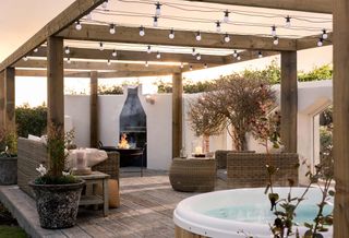Decking area with hot tub, pergola, rattan garden furniture and fire pit