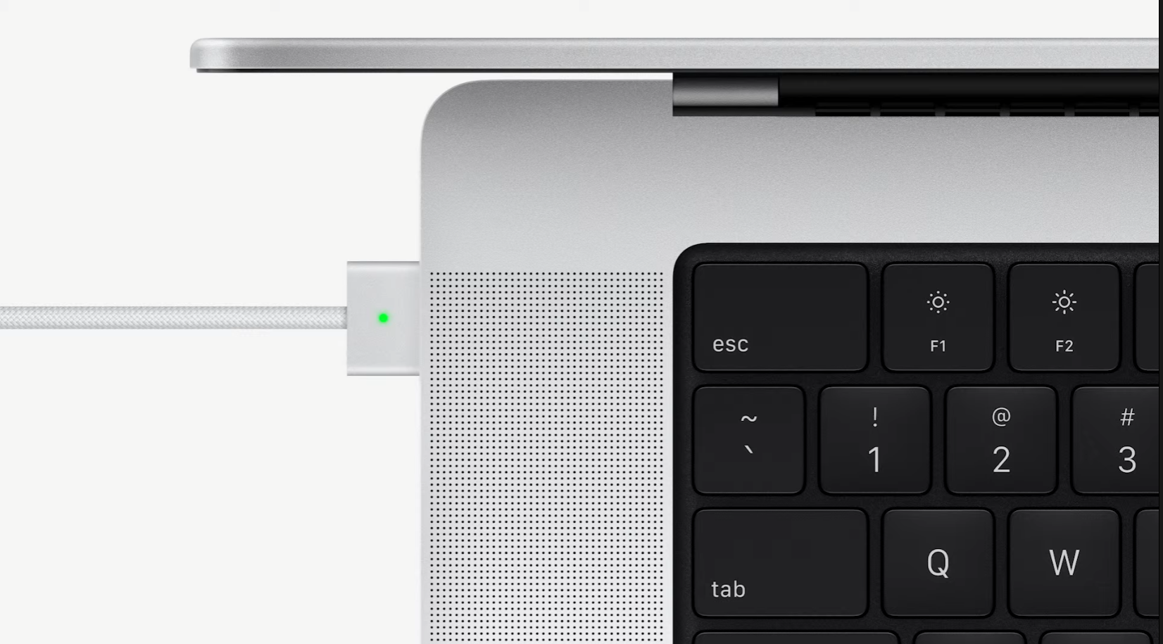 A close-up of the MagSafe 3 charger being plugged into a new MacBook Pro