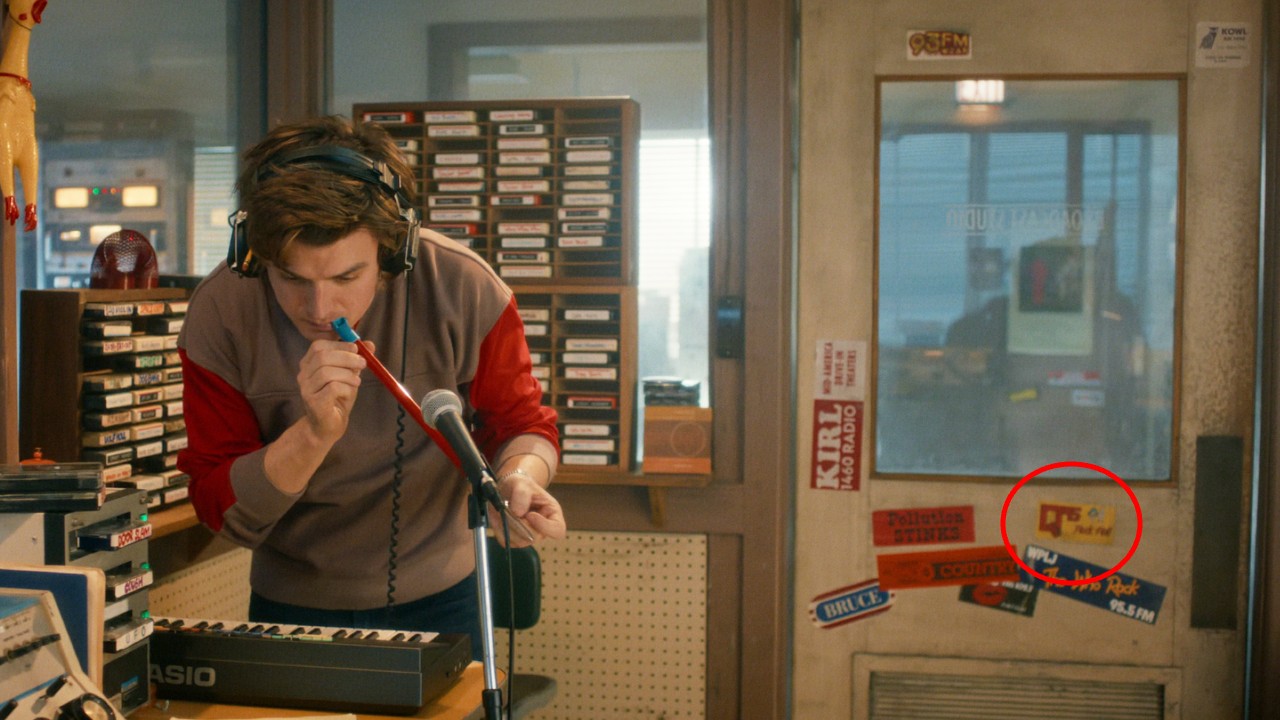 Steve on the radio with the Q95 sticker shown in the background highlighted with a red circle