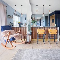 Breakfast bar area with two bar stools and blue rocking chair