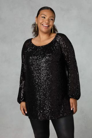 best party outfits - woman wearing black sequin long sleeve top