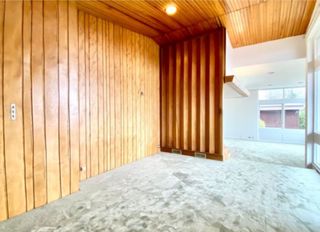 Parana pine wood panelling lines the walls and ceiling, which stands opposite the floor to ceiling windows