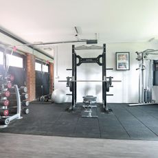 Home gym in garage with protective matting on the floor