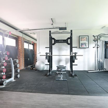 Home gym in garage with protective matting on the floor