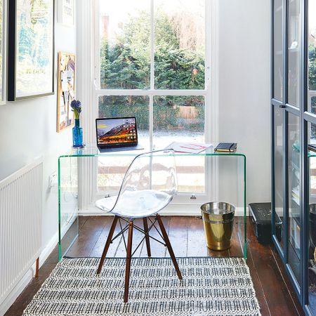 home office with transparent desk and laptop