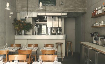 Silver & grey restaurant interior with wooden chairs & tables
