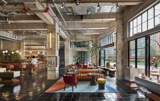 Fotografiska Shanghai by AIM Architecture showing the building's blend of old and new with raw concrete and plush interiors