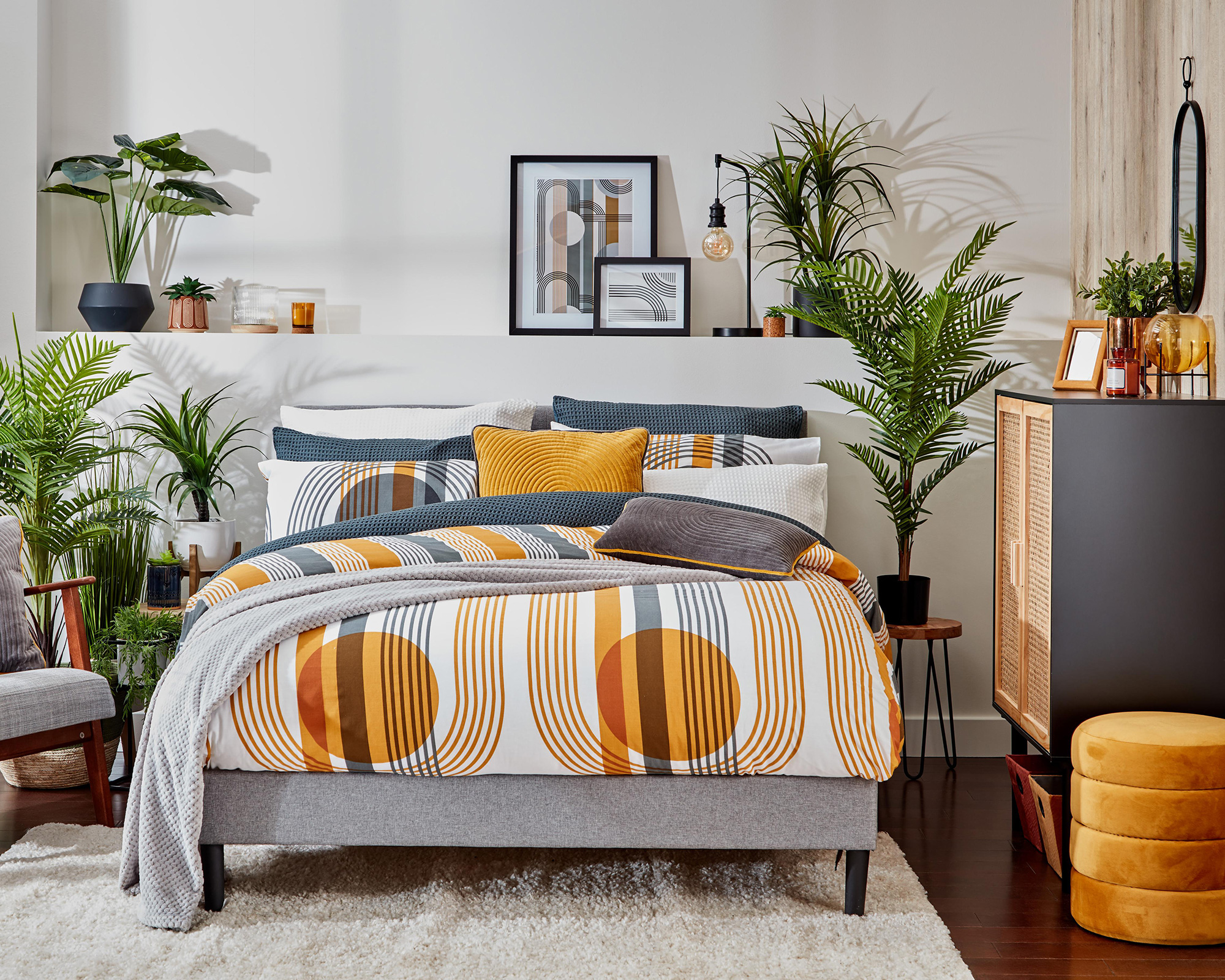 A retro bedroom scheme by B&M with mustard duvet and shelf behin bed