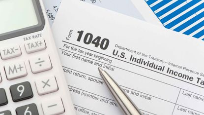 Close up of a Tax return form with calculator