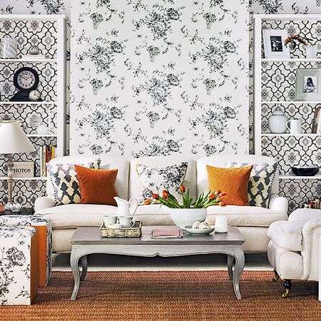 patterned wallpaper with carpet on floor and sofa with cushions and table