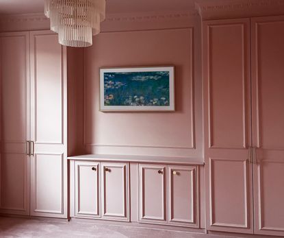 A pink color drenched bedroom with a built in IKEA pax wardrobe 