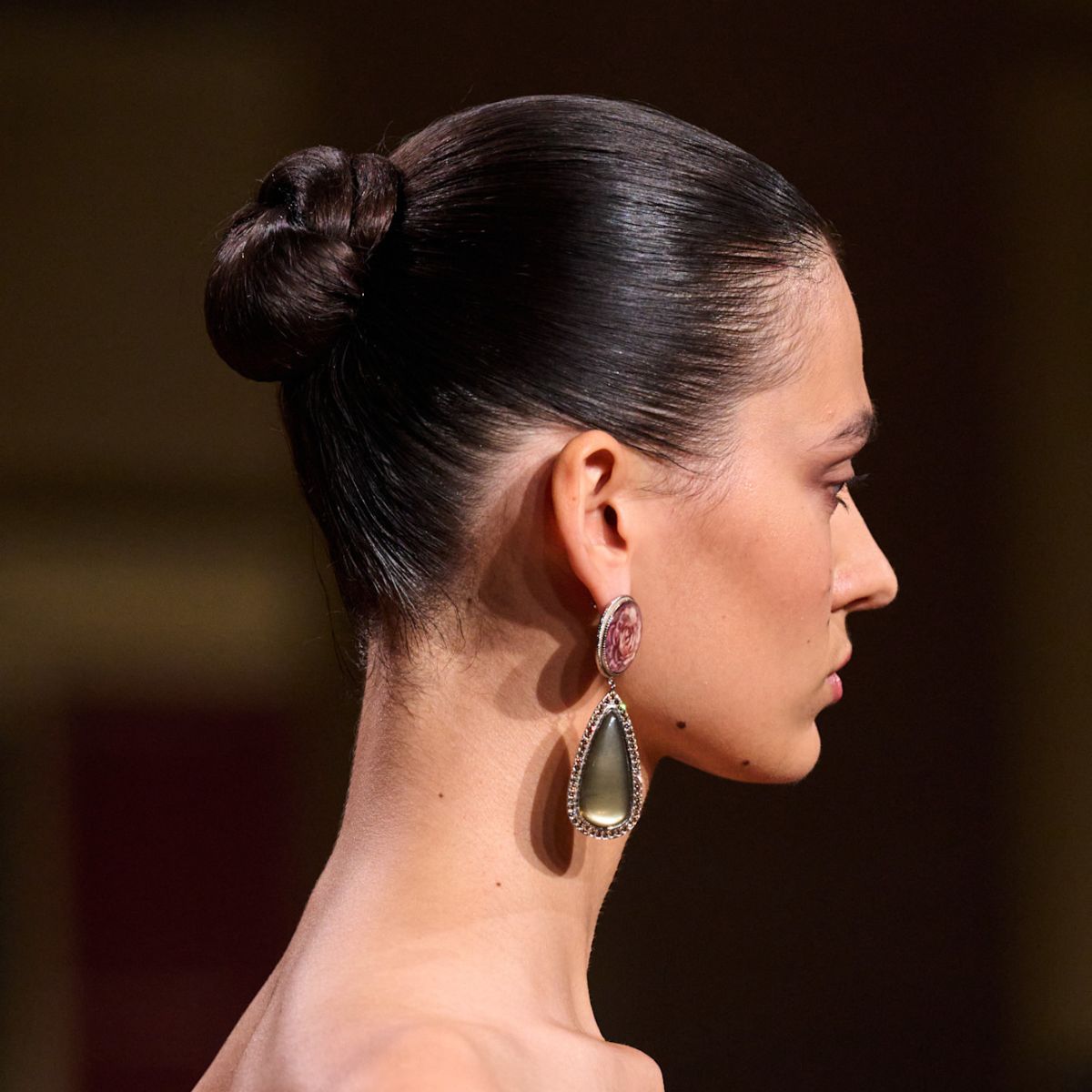 A slicked-back mid-height bun.