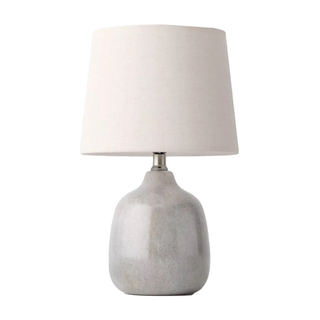 A grey ceramic stoneware-look table lamp with a shiny finish