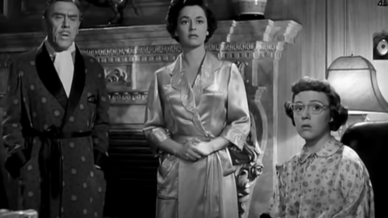 Leo G. Carroll, Ruth Roman, and Patricia Hitchcock staring in concern in Strangers on a Train
