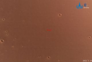 The red surface of Mars dotted by craters