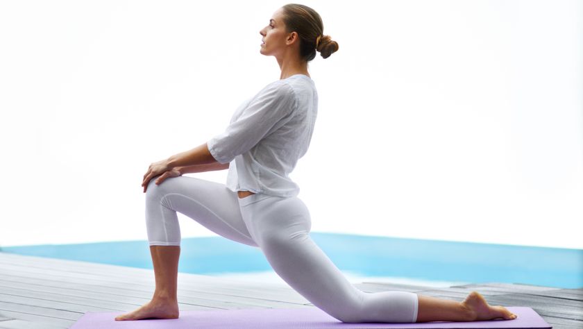 a woman leaning into a kneeling forward lunge