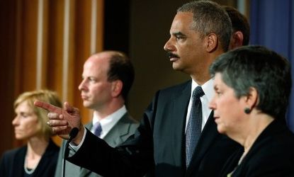 Eric Holder (center) says Faisal Shazad may have been associated with the Pakistani Taliban.