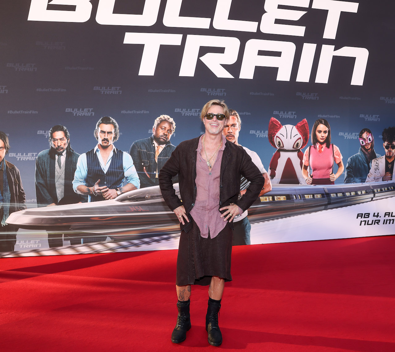Brad Pitt on the red carpet of Bullet Train in a skirt