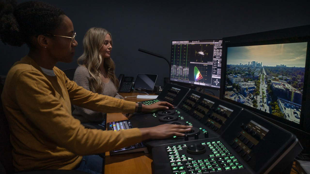 Two people working on Sony's BVM-HX3110 TRIMASTER HX Professional Grading Monitor