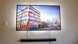A TV with a Philips Hue lightstrip mounted on its backside