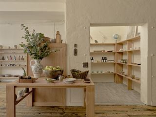 a store filled with ceramics and wooden furniture