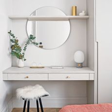 White painted bedroom with built-in vanity with wall mirror