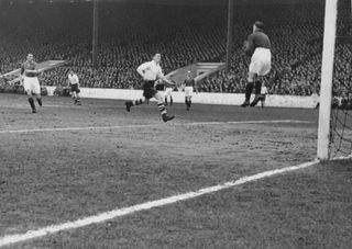 Manchester United player Allenby Chilton (left) watches keeper Jack Crompton make a save during a cup match against Preston North End at Old Trafford, February 1948. Original Publication : Picture Post - 4516 - A Team That Deserves The Cup - pub. 1948