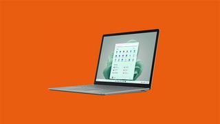 The Surface Laptop 5 on an orange background. 